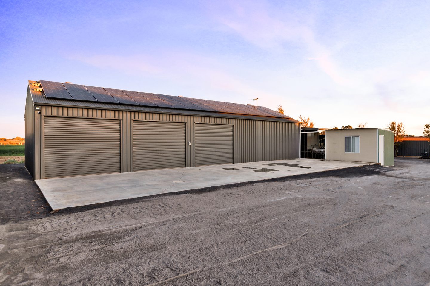 The shed and forecourt, with solar panels on the roof